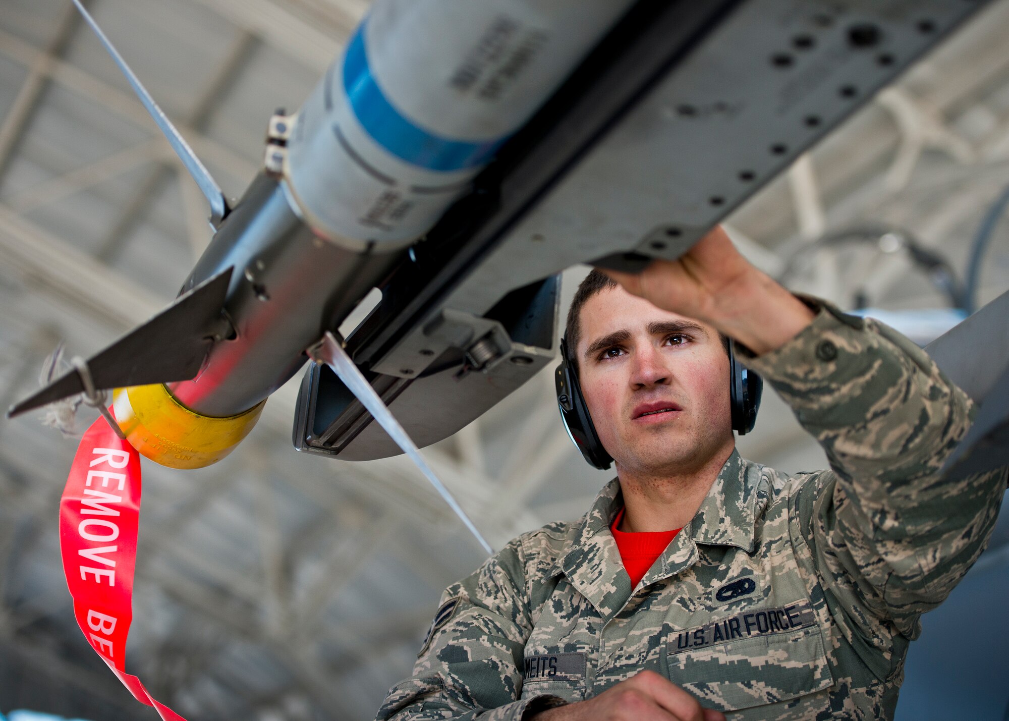 Airman 1st Class James Schmeits, 96th Aircraft Maintenance Squadron, ensures the AIM-9X is secured to the F-15 Eagle during the annual weapons load crew of the year competition Feb. 13 at Eglin Air Force Base, Fla.  Two F-16 Fighting Falcon and two F-15 teams loaded five weapons on their respective aircraft for the rights to be the load crew of the year for 2014.  The timed competition is judged on safety, speed and accuracy.  The winner of the competition will be announced at the 96th Maintenance Group’s annual awards banquet in March.  (U.S. Air Force photo/Samuel King Jr.)