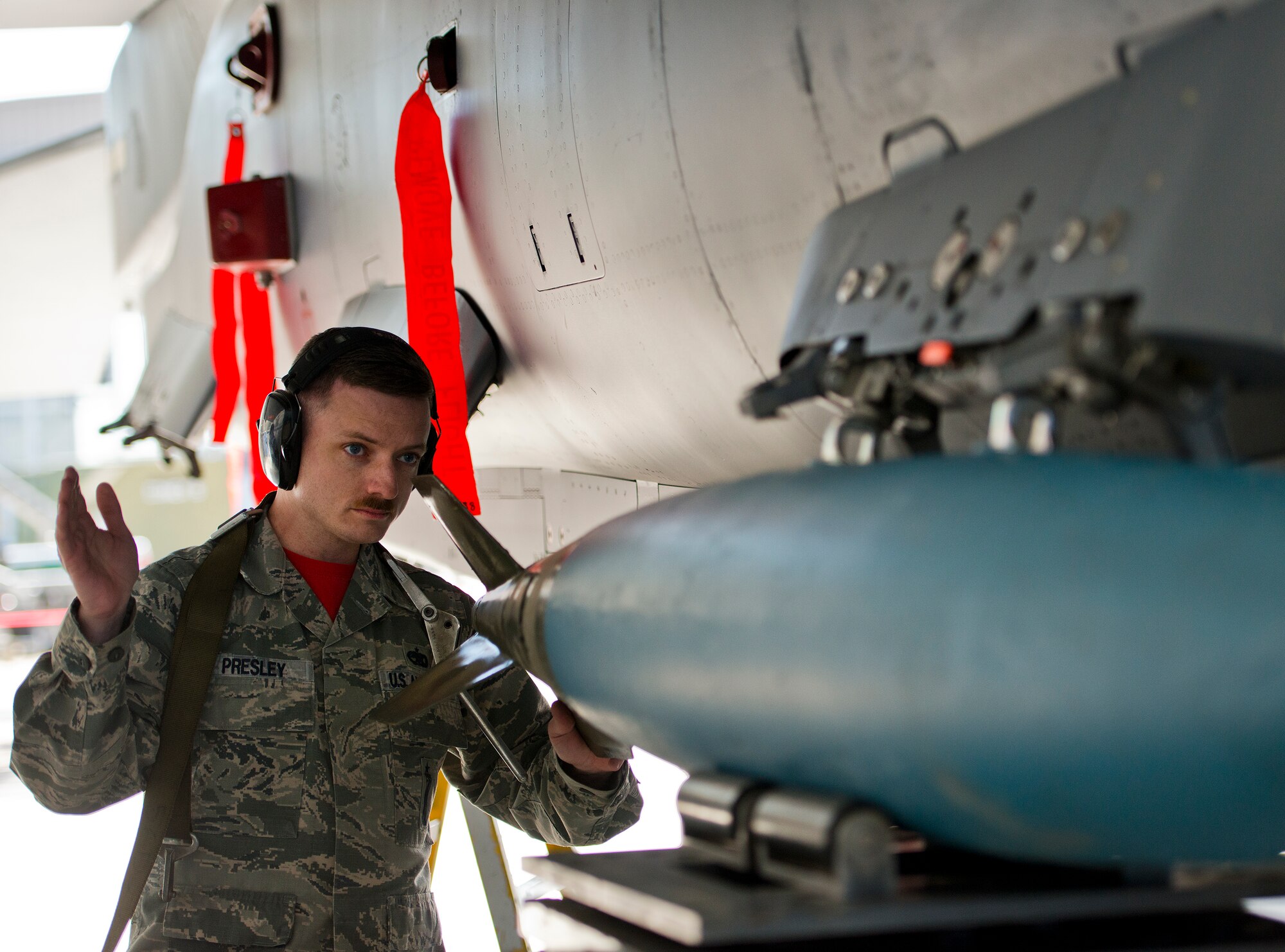 Staff Sgt. Stephen Presley, 96th Aircraft Maintenance Squadron, guides in a guided bomb unit onto his F-15 Eagle at the annual weapons load crew of the year competition Feb. 13 at Eglin Air Force Base, Fla.  Two F-16 Fighting Falcon and two F-15 teams loaded five weapons on their respective aircraft for the rights to be the load crew of the year for 2014.  The timed competition is judged on safety, speed and accuracy.  The winner of the competition will be announced at the 96th Maintenance Group’s annual awards banquet in March.  (U.S. Air Force photo/Samuel King Jr.)