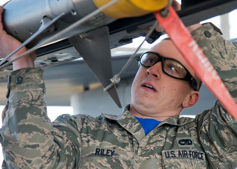 Airman 1st Class Trey Riley, 96th Aircraft Maintenance Squadron, secures an AIM-9X to an F-16 Fighting Falcon during the annual weapons load crew of the year competition Feb. 13 at Eglin Air Force Base, Fla.  Two F-16 and two F-15 Eagle teams loaded five weapons on their respective aircraft for the rights to be the load crew of the year for 2014.  The timed competition is judged on safety, speed and accuracy.  The winner of the competition will be announced at the 96th Maintenance Group’s annual awards banquet in March.  (U.S. Air Force photo/Tech. Sgt. Jasmin Taylor)