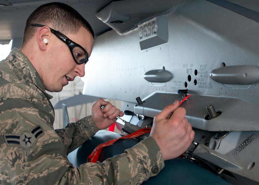 Airman 1st Class Trey Riley, 96th Aircraft Maintenance Squadron, secures a guided bomb unit to an F-16 Fighting Falcon during the annual weapons load crew of the year competition Feb. 13 at Eglin Air Force Base, Fla.  Two F-16 and two F-15 Eagle teams loaded five weapons on their respective aircraft for the rights to be the load crew of the year for 2014.  The timed competition is judged on safety, speed and accuracy.  The winner of the competition will be announced at the 96th Maintenance Group’s annual awards banquet in March.  (U.S. Air Force photo/Tech. Sgt. Jasmin Taylor)