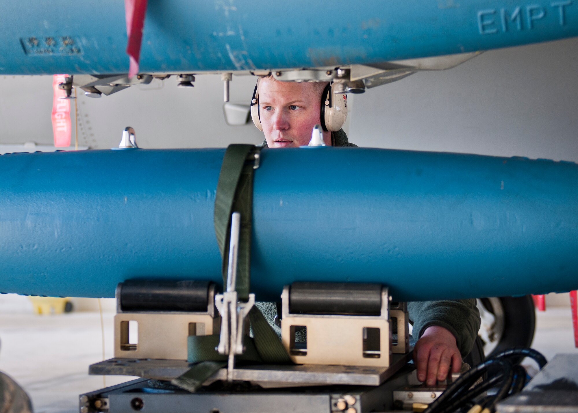 Staff Sgt. Mark Blinn, 96th Aircraft Maintenance Squadron, sights in the placement of a guided bomb unit onto an F-16 Fighting Falcon during the annual weapons load crew of the year competition Feb. 13 at Eglin Air Force Base, Fla.  Two F-16 and two F-15 Eagle teams loaded five weapons on their respective aircraft for the rights to be the load crew of the year for 2014.  The timed competition is judged on safety, speed and accuracy.  The winner of the competition will be announced at the 96th Maintenance Group’s annual awards banquet in March.  (U.S. Air Force photo/Samuel King Jr.)