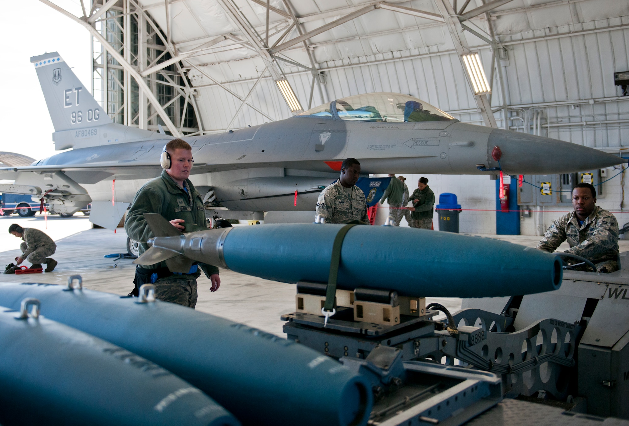 A 96th Aircraft Maintenance Squadron Blue F-16 Fighting Falcon team performs various tasks leading to the placement of a guided bomb unit on their aircraft during the annual weapons load crew of the year competition Feb. 13 at Eglin Air Force Base, Fla.  Two F-16 and two F-15 Eagle teams loaded five weapons on their respective aircraft for the rights to be the load crew of the year for 2014.  The timed competition is judged on safety, speed and accuracy.  The winner of the competition will be announced at the 96th Maintenance Group’s annual awards banquet in March.  (U.S. Air Force photo/Samuel King Jr.)