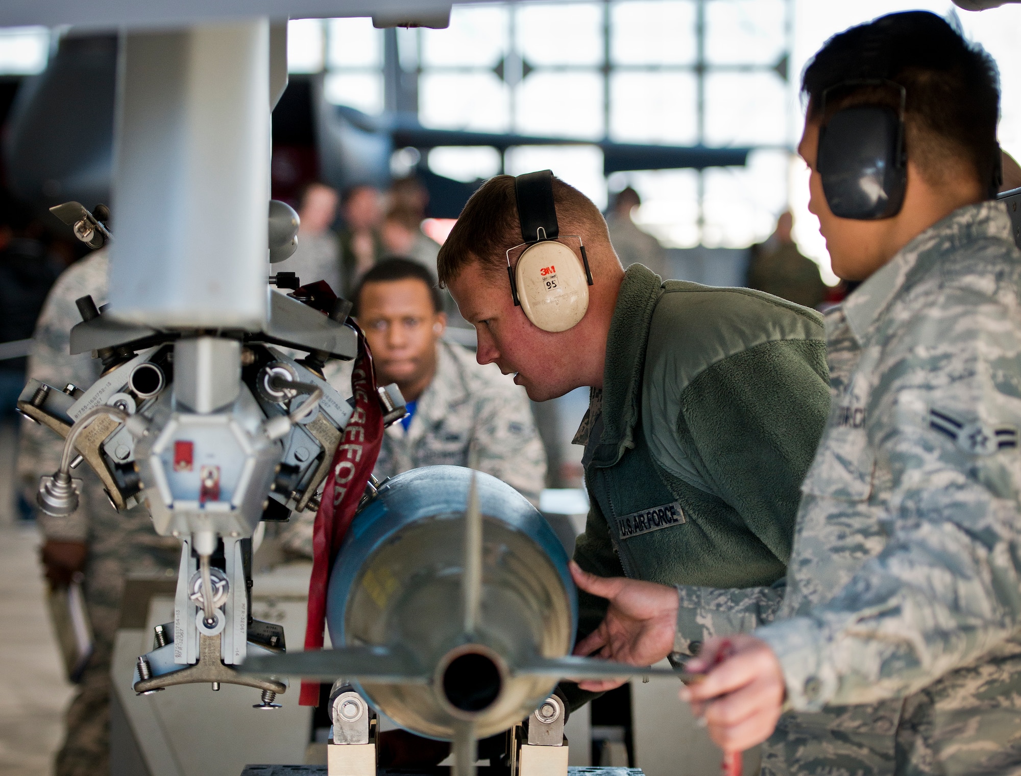 Staff Sgt. Mark Blinn, 96th Aircraft Maintenance Squadron, sights in the placement of a guided bomb unit onto an F-16 Fighting Falcon during the annual weapons load crew of the year competition Feb. 13 at Eglin Air Force Base, Fla.  Two F-16 and two F-15 Eagle teams loaded five weapons on their respective aircraft for the rights to be the load crew of the year for 2014.  The timed competition is judged on safety, speed and accuracy.  The winner of the competition will be announced at the 96th Maintenance Group’s annual awards banquet in March.  (U.S. Air Force photo/Samuel King Jr.)