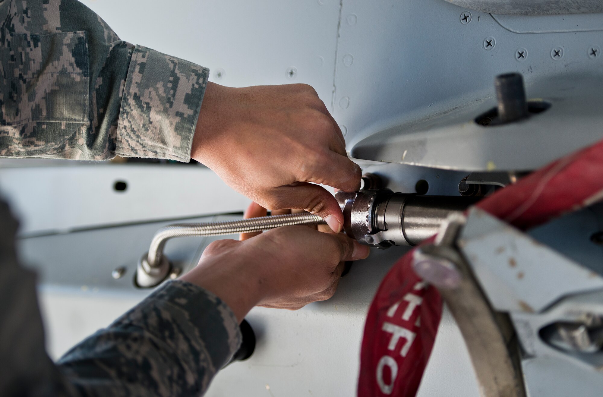Airman 1st Class Fred Guaren, 96th Aircraft Maintenance Squadron, secures a cable connection on an F-16 Fighting Falcon during the annual weapons load crew of the year competition Feb. 13 at Eglin Air Force Base, Fla.  Two F-16 and two F-15 Eagle teams loaded five weapons on their respective aircraft for the rights to be the load crew of the year for 2014.  The timed competition is judged on safety, speed and accuracy.  The winner of the competition will be announced at the 96th Maintenance Group’s annual awards banquet in March.  (U.S. Air Force photo/Samuel King Jr.)