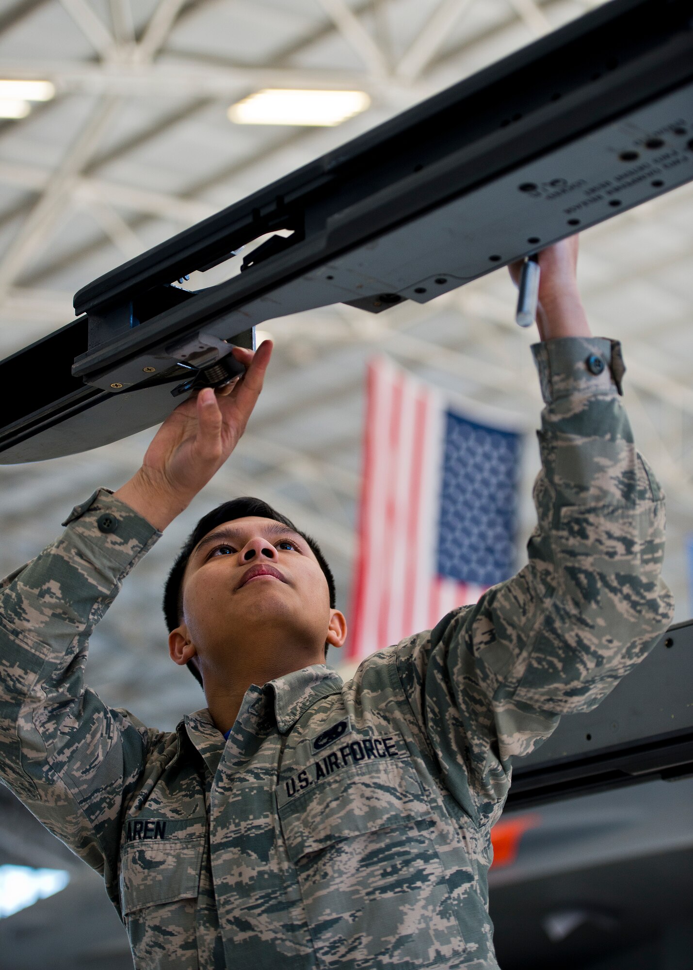 Airman 1st Class Fred Guaren, 96th Aircraft Maintenance Squadron, performs preload checks on an F-16 Fighting Falcon during the annual weapons load crew of the year competition Feb. 13 at Eglin Air Force Base, Fla.  Two F-16 and two F-15 Eagle teams loaded five weapons on their respective aircraft for the rights to be the load crew of the year for 2014.  The timed competition is judged on safety, speed and accuracy.  The winner of the competition will be announced at the 96th Maintenance Group’s annual awards banquet in March.  (U.S. Air Force photo/Samuel King Jr.)