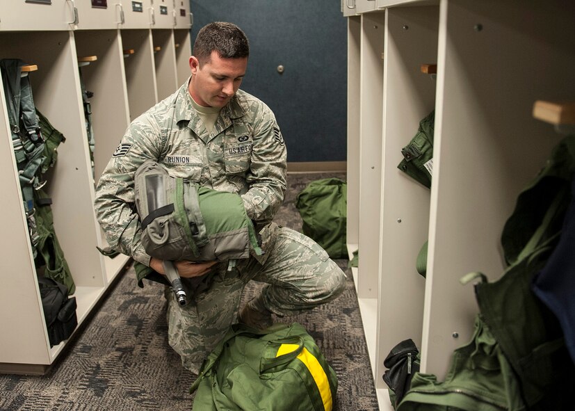 Staff Sgt. Steven Runion, of the 96th Operations Support Squadron, gathers flight equipment due for inspection at the 40th Flight Test Squadron on Eglin Air Force Base, Fla., Feb. 9.  The Aircrew Flight Equipment technicians maintain three shops at Eglin, a shop at Duke Field and a shop at Hurlburt Field.  The AFE shop supports aircrews and equipment for the F-15, F-16, A-10, CV-22, C-130 and the UH-1.  The equipment maintained ranges from oxygen connectors to complex targeting systems.  (U.S. Air Force Photo/Ilka Cole)