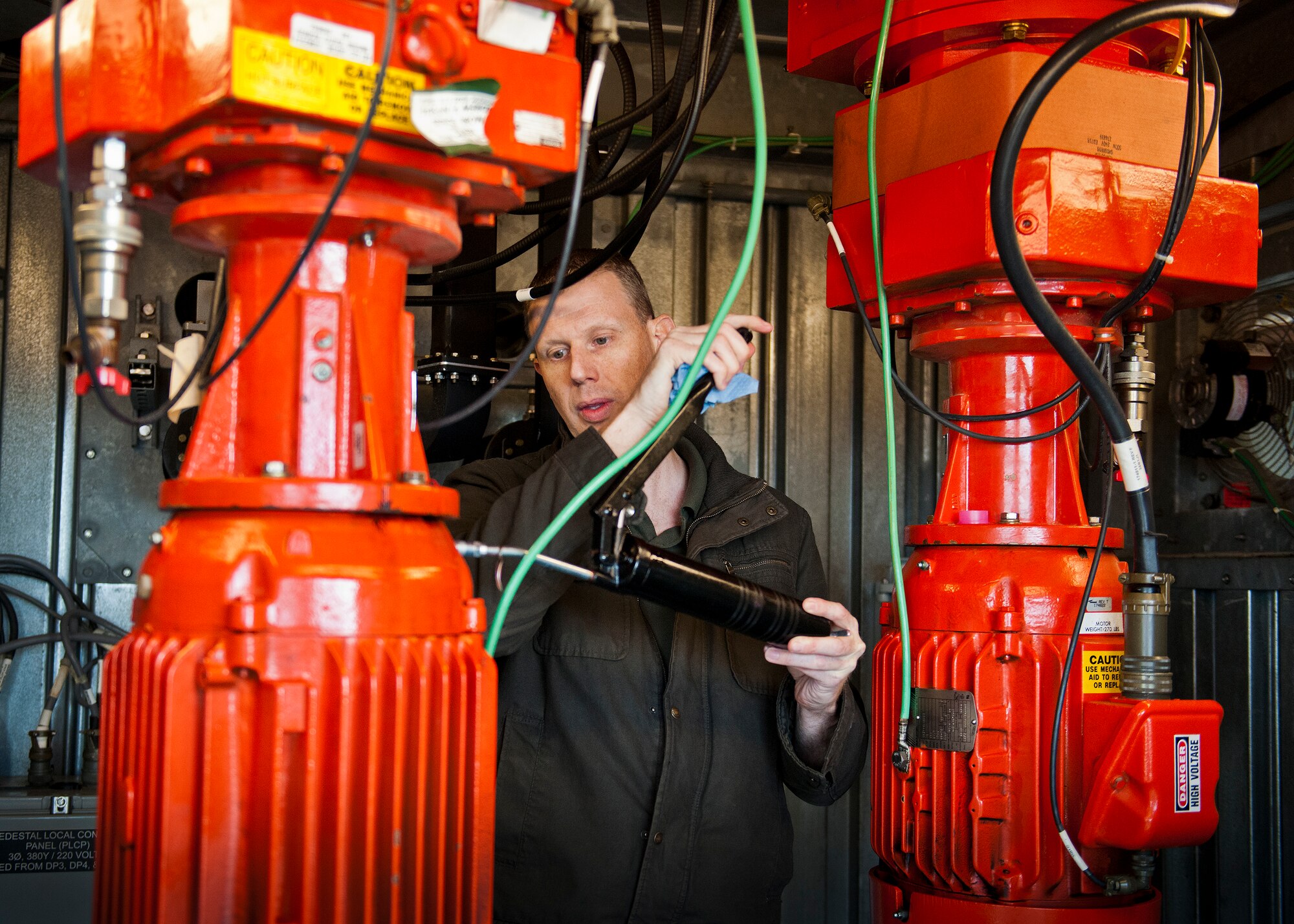 Robert Shepherd, 96th Operations Support Squadron, adds lubricant to one of Eglin Air Force Base radar’s engines during routine maintenance at the base’s radar facility.  The civilians in the 96th OSS’s Airfield Systems Maintenance Flight are responsible for all of the maintenance and repair of the tower and radar approach control’s electronic equipment as well as the radar itself. (U.S. Air Force photo/Samuel King Jr.)