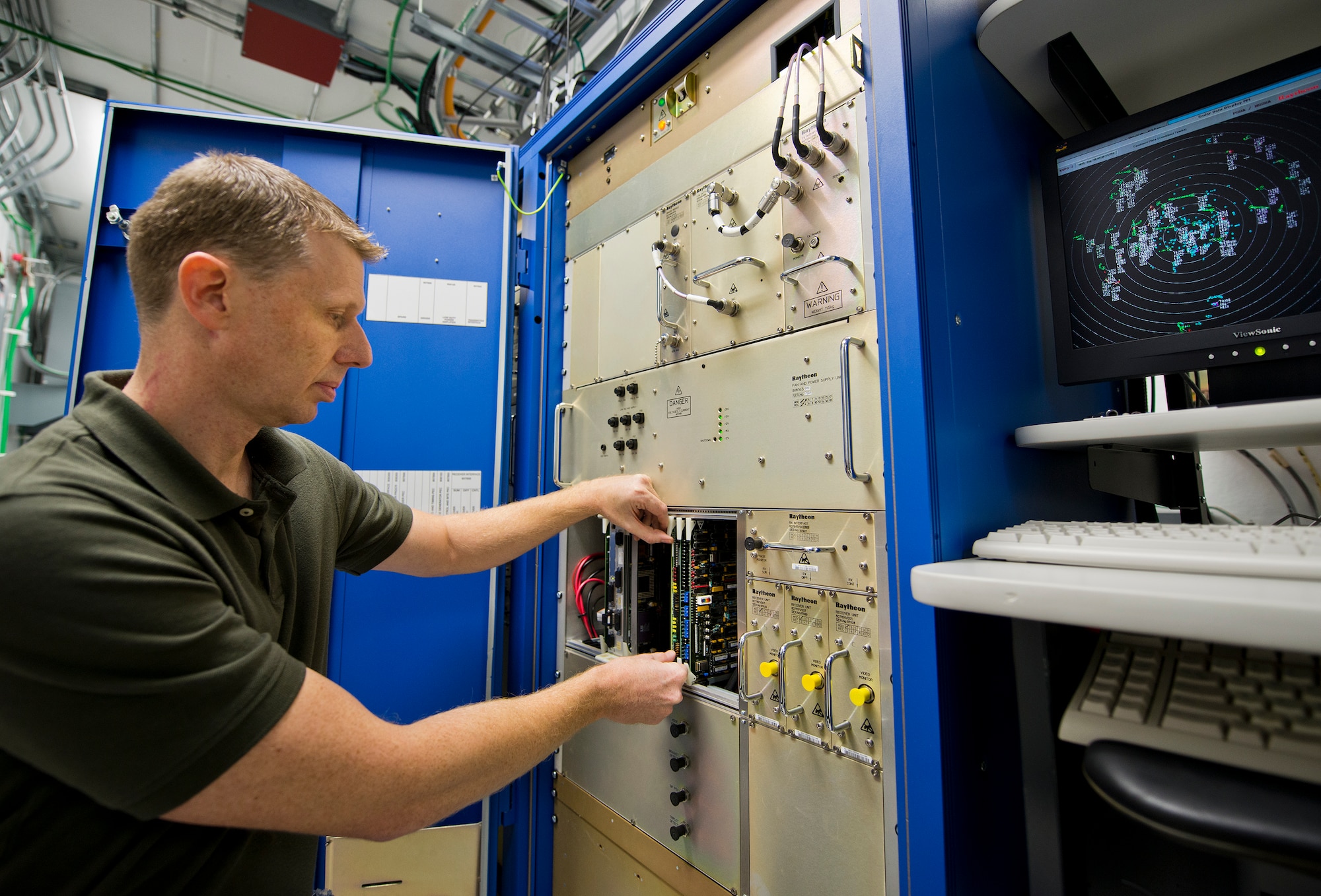 Robert Shepherd, 96th Operations Support Squadron, adjusts a board on the radar control panel at Eglin Air Force Base’s radar facility.  The civilians in the 96th OSS’s Airfield Systems Maintenance Flight are responsible for all of the maintenance and repair of the tower and radar approach control’s electronic equipment as well as the radar itself. (U.S. Air Force photo/Samuel King Jr.)