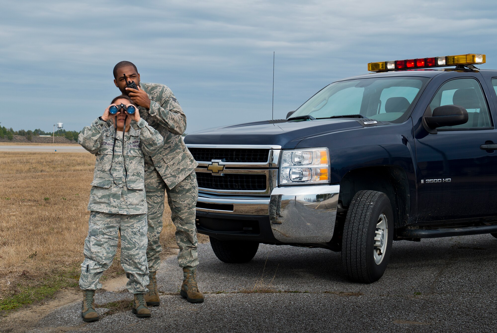 Master Sgt. Lesa Bollette-Harris and Senior Airman Justin Smith, 96th Operations Support Squadron, monitor the Eglin Air Force Base, Fla., flight line as part of their duties at airfield operations.  The members of the flight are charged with maintaining safety and security of the aircraft, vehicles and personnel on the flightline. (U.S. Air Force photo/Samuel King Jr.)