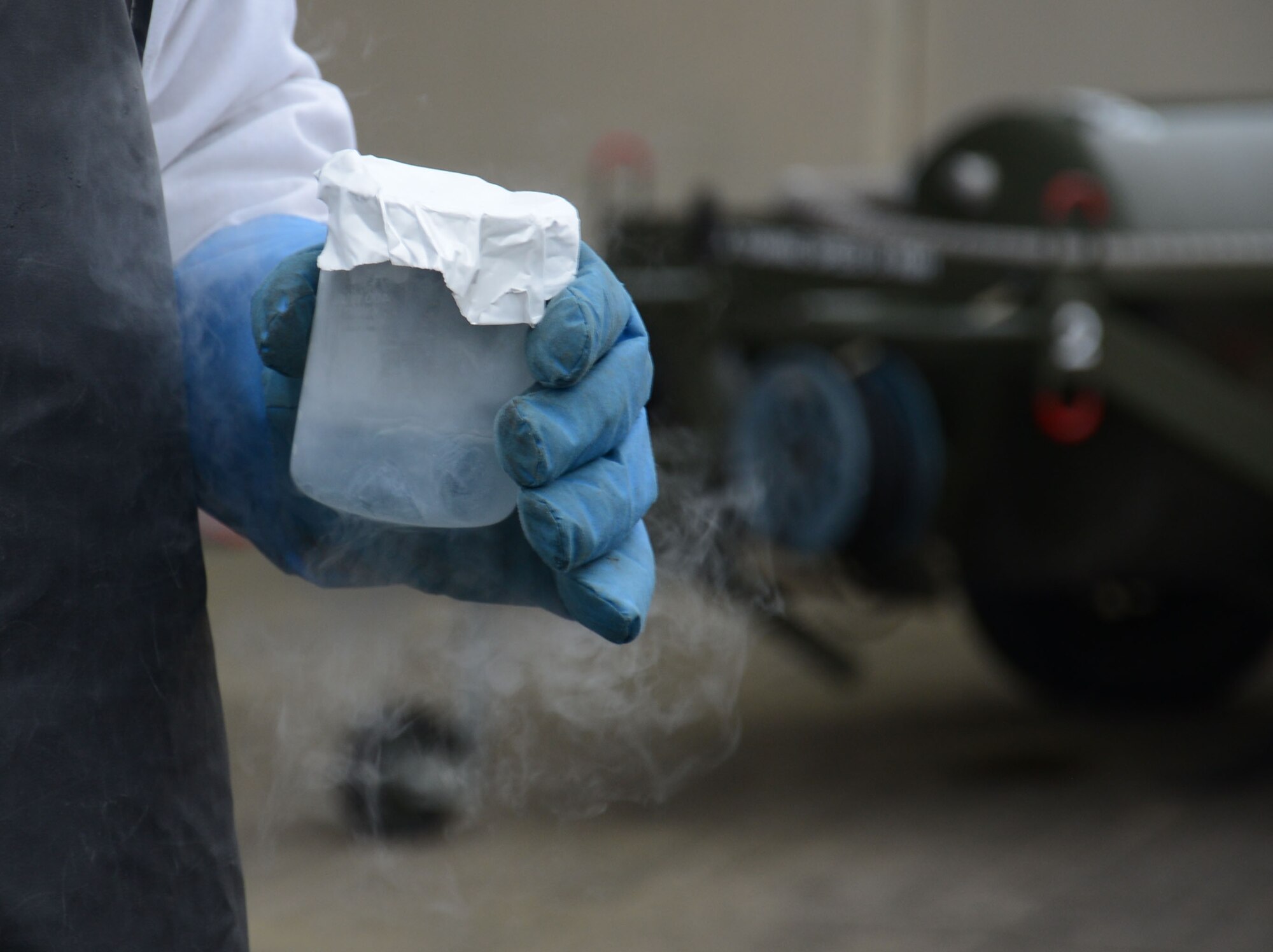 U.S. Air Force Senior Airman Matthew Dillard, 100th Logistics Readiness Squadron cryogenic specialist from Las Vegas, Nev., samples liquid oxygen from the 50-gallon liquid oxygen cart Feb. 11, 2015, on RAF Mildenhall, England. The Airmen working with Dillard take an odor sample of 200-milliliters of liquid oxygen regularly to ensure the liquid oxygen supplied to aircraft is free from contamination. (U.S. Air Force photo by Gina Randall/Released)