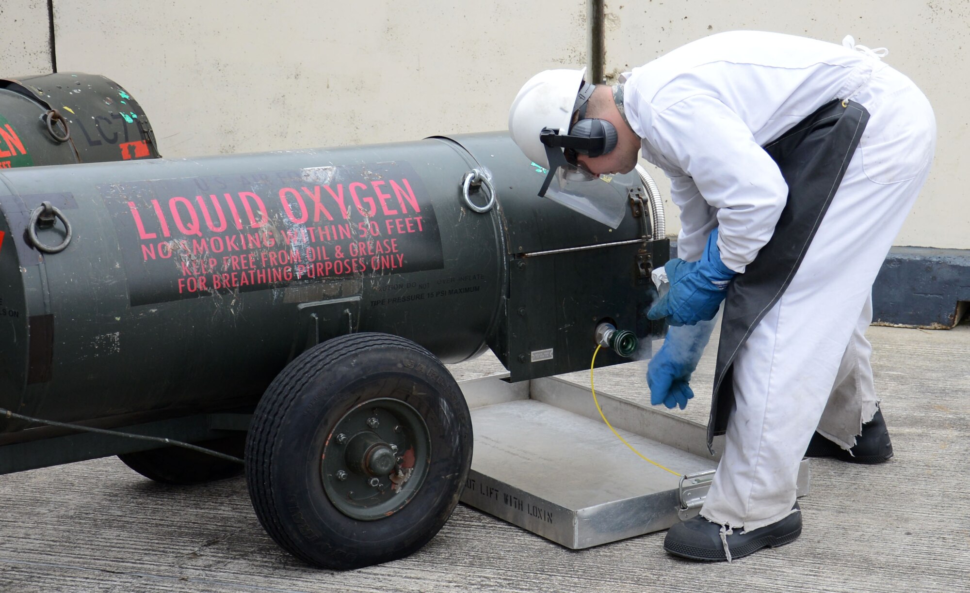 U.S. Air Force Senior Airman Matthew Dillard, 100th Logistics Readiness Squadron cryogenic specialist from Las Vegas, Nev., obtains a 200-milliliter odor sample from a 50-gallon cart Feb. 11, 2015, on RAF Mildenhall, England. It’s vital that liquid oxygen is checked for contamination regularly to ensure only pure liquid oxygen reaches the aircraft. (U.S. Air Force photo by Gina Randall/Released)