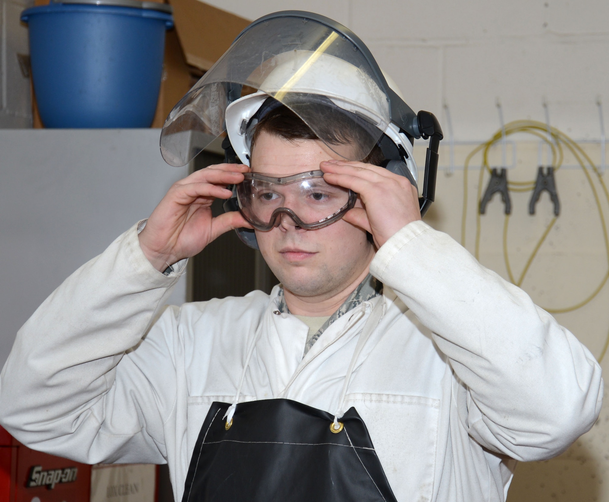 U.S. Air Force Senior Airman Matthew Dillard, 100th Logistics Readiness Squadron cryogenic specialist from Las Vegas, Nev., secures his safety eyewear prior to draining off the pressure on the main liquid oxygen storage tank Feb. 11, 2015, on RAF Mildenhall, England. Correct personal protective equipment is vital to Airmen working with liquid oxygen. (U.S. Air Force photo by Gina Randall/Released)