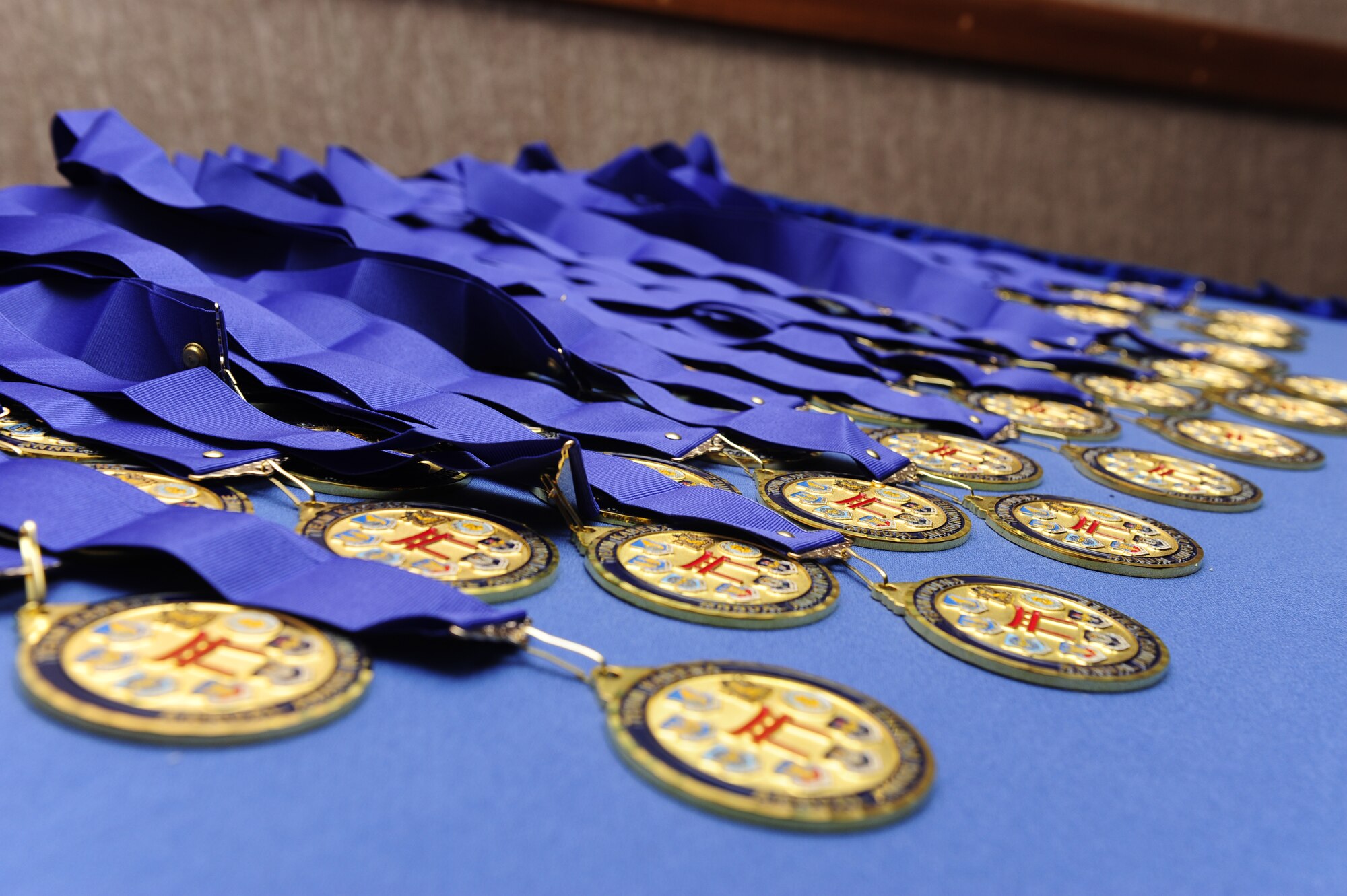 18th Wing, Partner Unit and Team Kadena award nomination medals are arranged on a table to be given to nominees preceding the 2014 Team Kadena Annual Awards banquet at the Rocker NCO Club on Kadena Air Base, Japan, Feb. 21, 2015. During the banquet, 17 winners were chosen from 11 different organizational groups and the Kadena Honor Guard as the top performers for  2014. (U.S. Air Force photo by Airman 1st Class John Linzmeier)