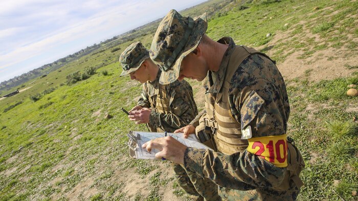 Recruits Jacob R. Kottman and Chainey L. Ellis, (right to left) Platoon 2105, Echo Company, 2nd Recruit Training Battalion, determine the direction to their next mark during the Land Navigation Course at Edson Range, Marine Corps Base Camp Pendleton, Calif., Jan. 22.  Recruits had to utilize teamwork and confidence in each other’s skills while making their way through the course.