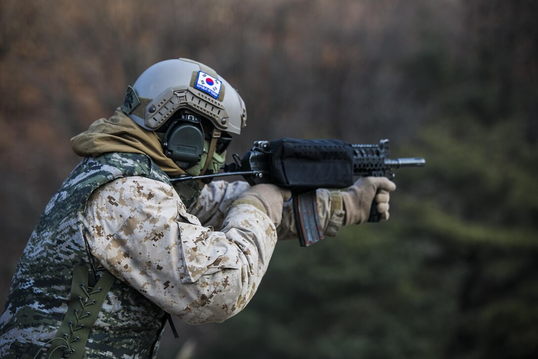 U.S. Marine Cpl. Richard J. Bennaugh fires rounds from a Daewoo K1 submachine gun Feb. 5 during Korean Marine Exchange Program 15-3 at Gimpo, Republic of Korea. The U.S. Marines were given the unique opportunity to also test out the Daewoo K2 assault rifle, Daewoo K5 handgun, the K201 40mm grenade launcher and the Daewoo K14 sniper rifle. Bennaugh, from Pittsburgh, Pennsylvania, is a reconnaissance man with Alpha Company, 3rd Reconnaissance Battalion, 3rd Marine Division, III Marine Expeditionary Force. 