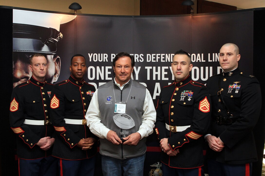 Rob Trifone, center, the head coach of Darien High School, poses for a photo with Marines from Marine Recruiting Station Springfield, Mass., after receiving the Semper Fi Coach Award during a Glazier Football Clinic on Feb. 21. The award recognizes a high school football coach who exemplifies the Marine Corps motto: Semper Fidelis, always faithful, and who models the Marine Corps’ core values of honor, courage and commitment. (Official Marine Corps photo by Staff Sgt. Richard Blumenstein.)