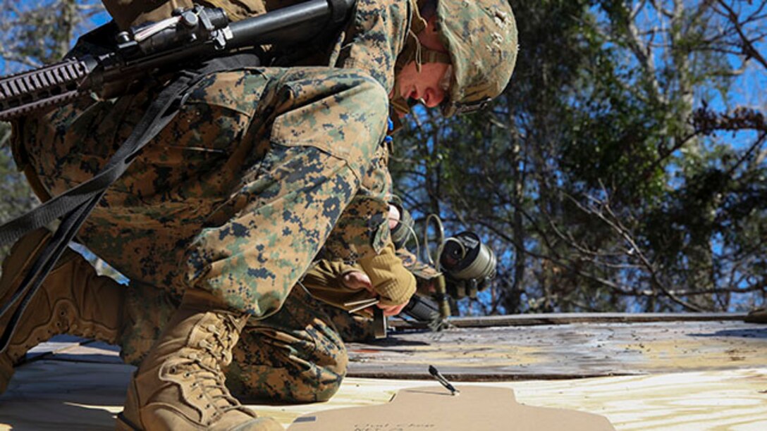 Marines with 2nd Combat Engineer Battalion set up an explosive charge on a rooftop during their urban breaching training exercise on Engineer Training Area-1 aboard Marine Corps Base Camp Lejeune, N.C., Feb. 19, 2015. During the training, the unit learned how to open any type of door, gate or roof using a variety of tools from explosives to shotguns and sledge hammers. They learned to do whatever was necessary to allow the infantry squad they were supporting to enter the building.