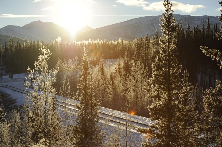 The sun sets behind the mountains in Denali National Park, Alaska, Jan. 19, 2015. Denali National Park encompasses over 6 million acres of land, containing hundreds of miles of trails and is home to Mount McKinley, the highest peak in North America. (U.S. Air Force photo by 1st Lt. Elias Zani/Released)