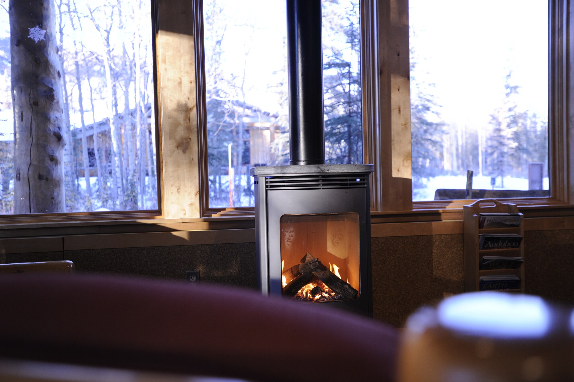 National Park Service employees keep a fire going in the Murie Science and Learning Center for park visitors to warm up while at Denali National Park, Alaska, Jan. 19, 2015. The Murie Science and Learning Center doubles as the visitor’s center during the winter months. (U.S. Air Force photo by 1st Lt. Elias Zani/Released)