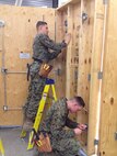 Marines of BE 3-15 conduct practical application on interior wiring.