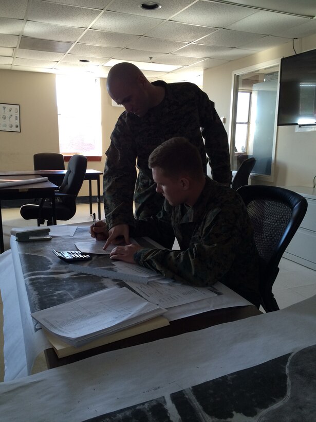 Marines in UC 2-15 conduct practical application in planning support in a field environment.