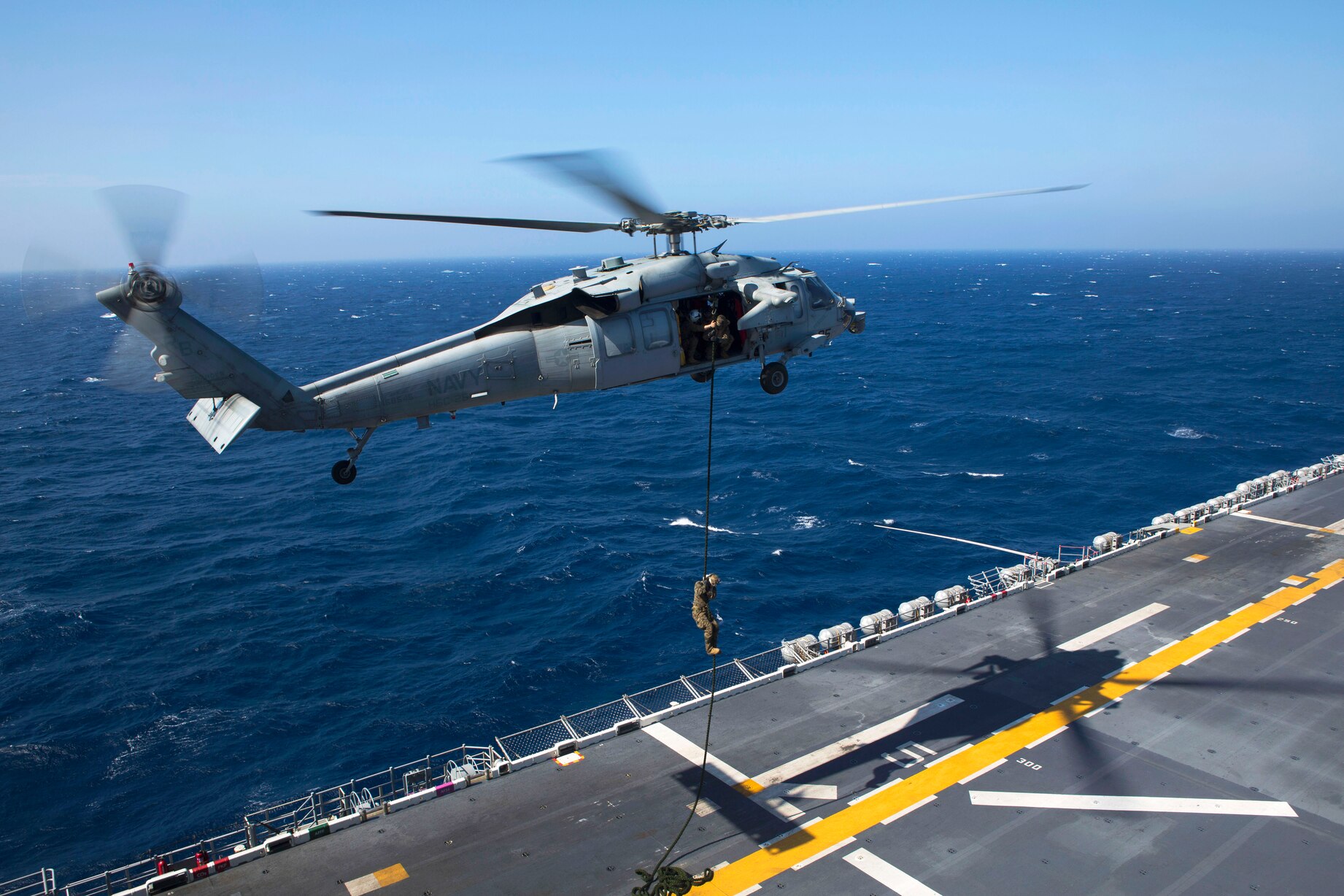 A Us Marine Fast Ropes Out Of An Mh 60 Seahawk Helicopter Aboard The 