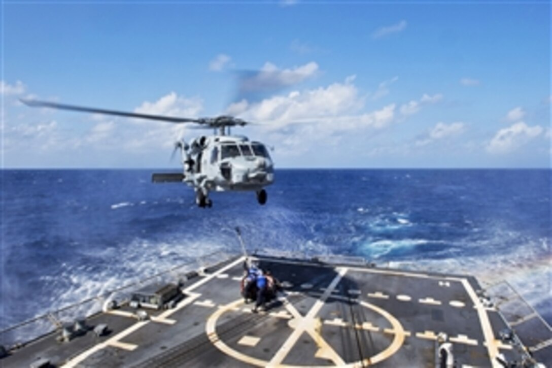 U.S. Navy Seamen Steven Lopez and Nickey Barnes practice vertical replenishment with an SH-60 Seahawk helicopter on the flight deck of the guided-missile destroyer USS Jason Dunham in the Caribbean Sea, Feb.18, 2015. The destroyer is supporting Operation Martillo, a joint operation with the U.S. Coast Guard and partner nations, in the U.S. 4th Fleet area of responsibility. The helicopter is assigned to Helicopter Maritime Strike Squadron 46.