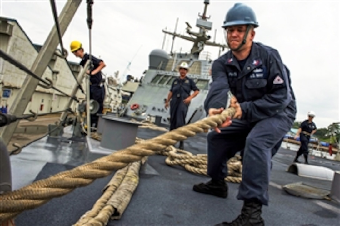 U.S. Navy Petty Officer 1st Class Robert Parks heaves a mooring line on the forecastle of the littoral combat ship USS Fort Worth during a detail in Sembawang, Singapore, Feb. 19, 2015. The combat ship is on a 16-month deployment to support the Asia-Pacific rebalance.