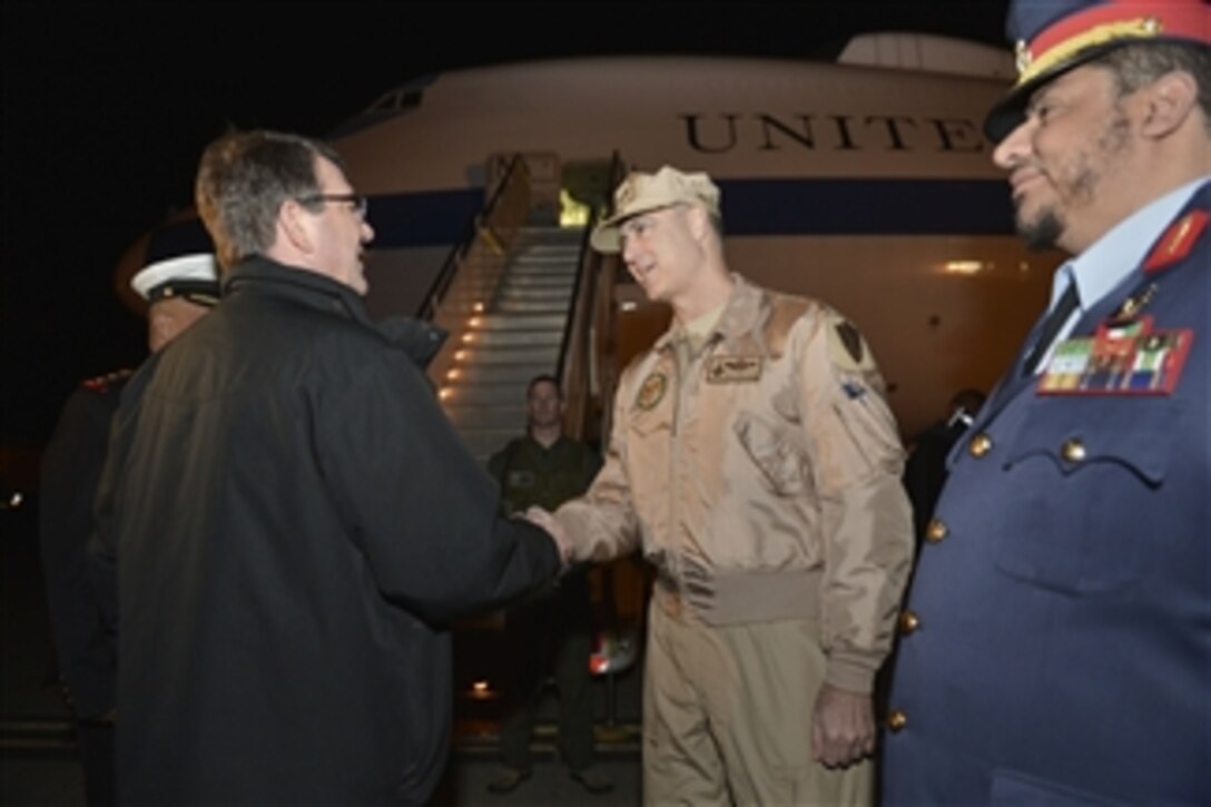 U.S. Defense Secretary Ash Carter bids farewell to U.S. Air Force Maj. Gen. Robert S. Williams, chief of the Office of Military Cooperation at the U.S. Embassy in Kuwait, as he boards his plane after visiting the country, Feb. 24, 2015.