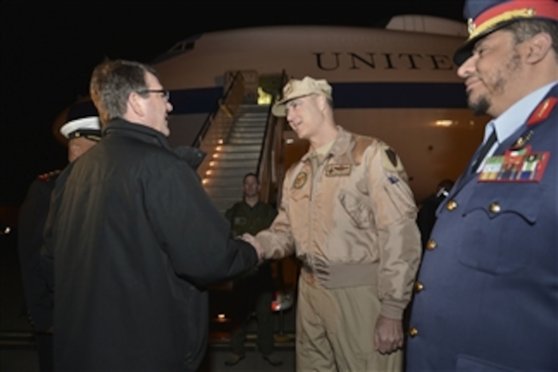 U.S. Defense Secretary Ash Carter bids farewell to U.S. Air Force Maj. Gen. Robert S. Williams, chief of the Office of Military Cooperation at the U.S. Embassy in Kuwait, as he boards his plane after visiting the country, Feb. 24, 2015.