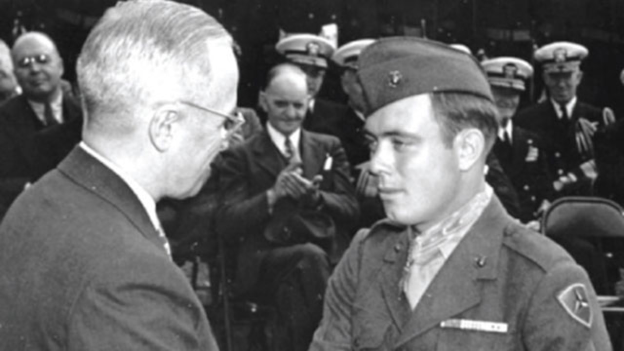 President Truman talks to Marine.