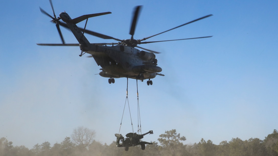 A CH-53E Super Stallion flies an M777-A2 Howitzer to the next training area, aboard Camp Lejeune, North Carolina, Feb. 19, 2015. 1st Battalion, 10th Marine Regiment conducted a live-fire training exercise that required them to be able to shoot, move, and communicate over a large area, in order to support fellow Marines. (U.S. Marine Corps photo by Cpl. Kaitlyn Klein/Released)