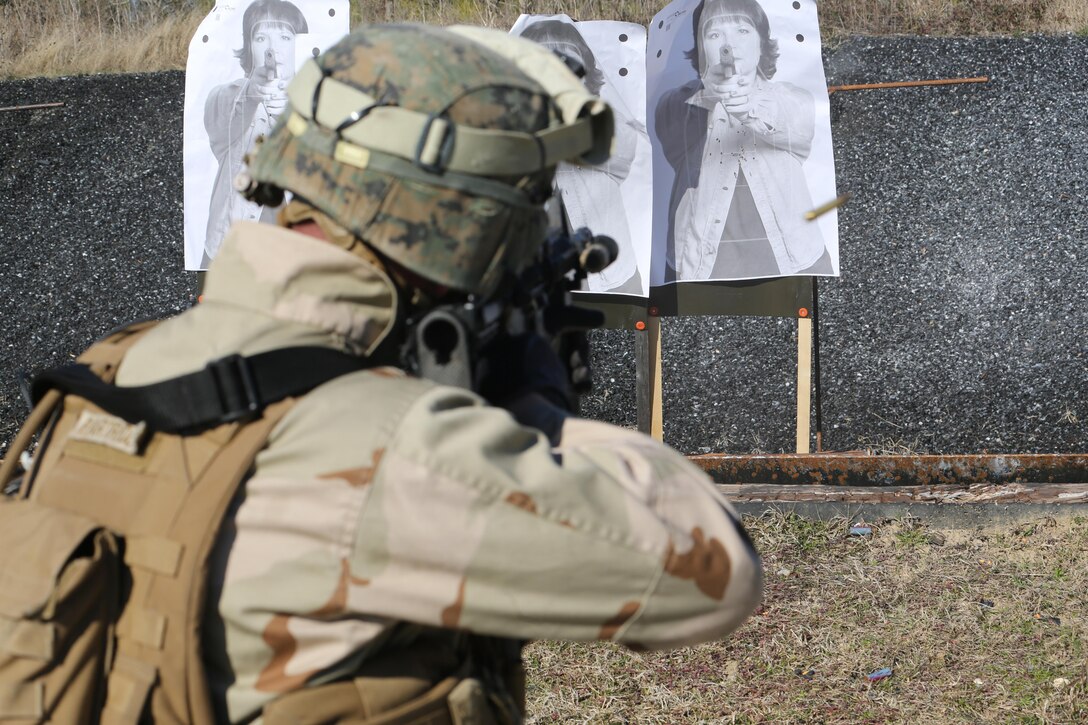 A Marine with 2nd Combat Engineer Battalion, 2nd Marine Division, fires an M4 carbine rifle at a range here, Feb. 10, 2015. Critical Skills Operators with 3rd Marine Special Operations Battalion, U.S. Marine Corps Forces Special Operations Command, trained with 2nd CEB Marines during RAVEN 15-03, a 10-day realistic military training exercise to enhance 3rd MSOB’s readiness for worldwide support to global security. Marines with 2nd CEB played the role of a partner nation force during the exercise. (Official U.S. Marine Corps photo by GySgt. Josh Higgins/released)