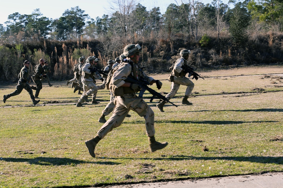 Marines with 2nd Combat Engineer Battalion, 2nd Marine Division, run to a firing point at a range here, Feb. 10, 2015. Critical Skills Operators with 3rd Marine Special Operations Battalion, U.S. Marine Corps Forces Special Operations Command, trained with 2nd CEB Marines during RAVEN 15-03, a 10-day realistic military training exercise to enhance the battalion’s readiness for worldwide support to global security. Marines with 2nd CEB played the role of a partner nation force during the exercise. (Official U.S. Marine Corps photo by GySgt. Josh Higgins/released)