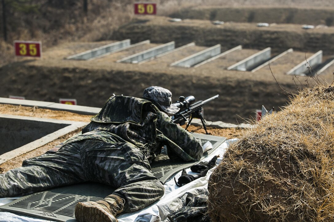 A Republic of Korea Marine zeroes out his weapon before teaching U.S. Marines how to fire it Feb. 5 during Korean Marine Exchange Program 15-3 at Gimpo, Republic of Korea. Zeroing the weapon, combined with the proper application of the fundamentals of marksmanship, allows for the rifle optics to align with the targets downrange. U.S. Marines also learned different characteristics of the weapon. The U.S. Marines are reconnaissance men with Alpha Company, 3rd Reconnaissance Battalion, 3rd Marine Division, III Marine Expeditionary Force. The ROK Marines are with 2nd Battalion, 2nd Marine Division.