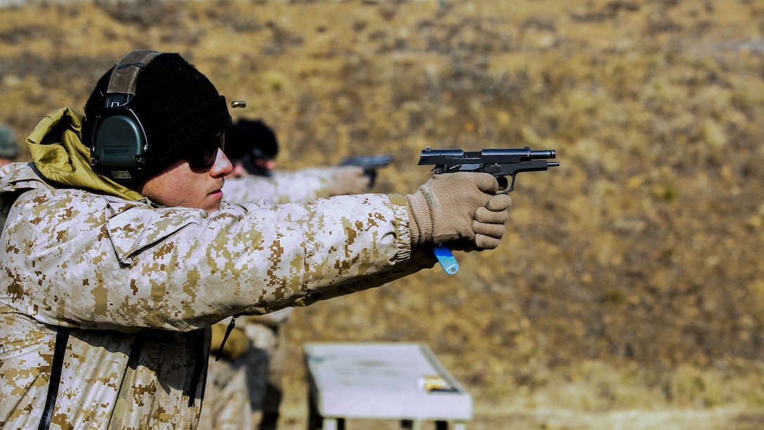U.S. Marine Cpl. David A. Range fires rounds from a Daewoo K5 handgun into a target Feb. 5 during Korean Marine Exchange Program 15-3 at Gimpo, Republic of Korea. The U.S. Marines were given the unique opportunity to also test out the Daewoo K2 assault rifle, Daewoo K1 submachine gun, the K201 40mm grenade launcher and the Daewoo K14 sniper rifle. Range, from Arlington, Texas, is a reconnaissance man with Alpha Company, 3rd Reconnaissance Battalion, 3rd Marine Division, III Marine Expeditionary Force.