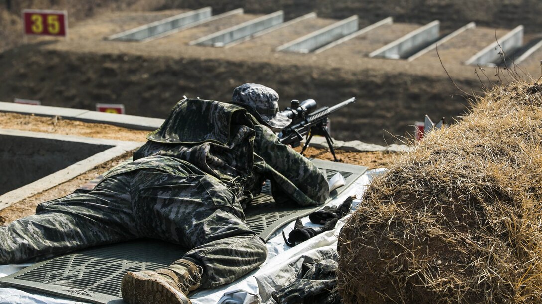 A Republic of Korea Marine zeroes out his weapon before teaching U.S. Marines how to fire it Feb. 5 during Korean Marine Exchange Program 15-3 at Gimpo, Republic of Korea. Zeroing the weapon, combined with the proper application of the fundamentals of marksmanship, allows for the rifle optics to align with the targets downrange. U.S. Marines also learned different characteristics of the weapon. The U.S. Marines are reconnaissance men with Alpha Company, 3rd Reconnaissance Battalion, 3rd Marine Division, III Marine Expeditionary Force. The ROK Marines are with 2nd Battalion, 2nd Marine Division.