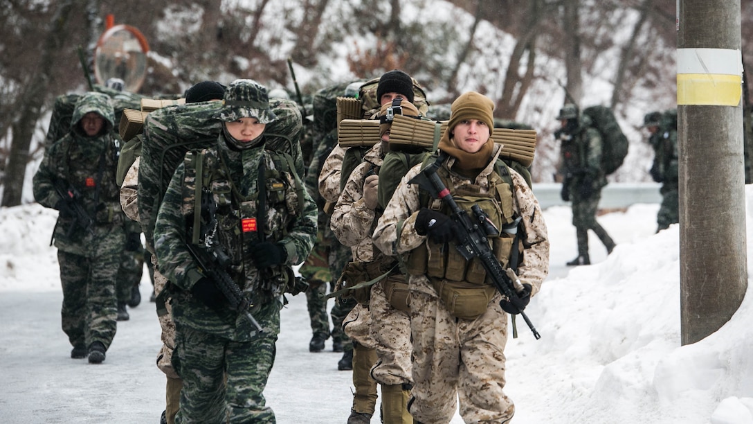 U.S. and Republic of Korea Marines hike a 35- km path up a mountain Jan. 15 during Korean Marine Exchange Program 15-3 in Pyeongchang, Republic of Korea. The U.S. Marines hiked side-by-side with their ROK Marine counterparts through snow and ice. The U.S. Marines are reconnaissance men with Alpha Company, 3rd Reconnaissance Battalion, 3rd Marine Division, III Marine Expeditionary Force. The ROK Marines are force reconnaissance men with 2nd Battalion, 2nd Marine Division. 