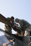 Spc. Austin Bennett, left, and Cadet Bryan Honeycutt, both assigned to the North Carolina Army National Guard’s 1st Battalion, 130th Aviation Regiment, perform routine maintenance on an AH-64D Apache Longbow helicopter during a training event at the North Carolina Army National Guard flight facility in Morrisville, N.C. Bennett and Honeycutt are part of a broad range of Soldiers from the unit that work to keep the aircraft mission ready and capable at all times.