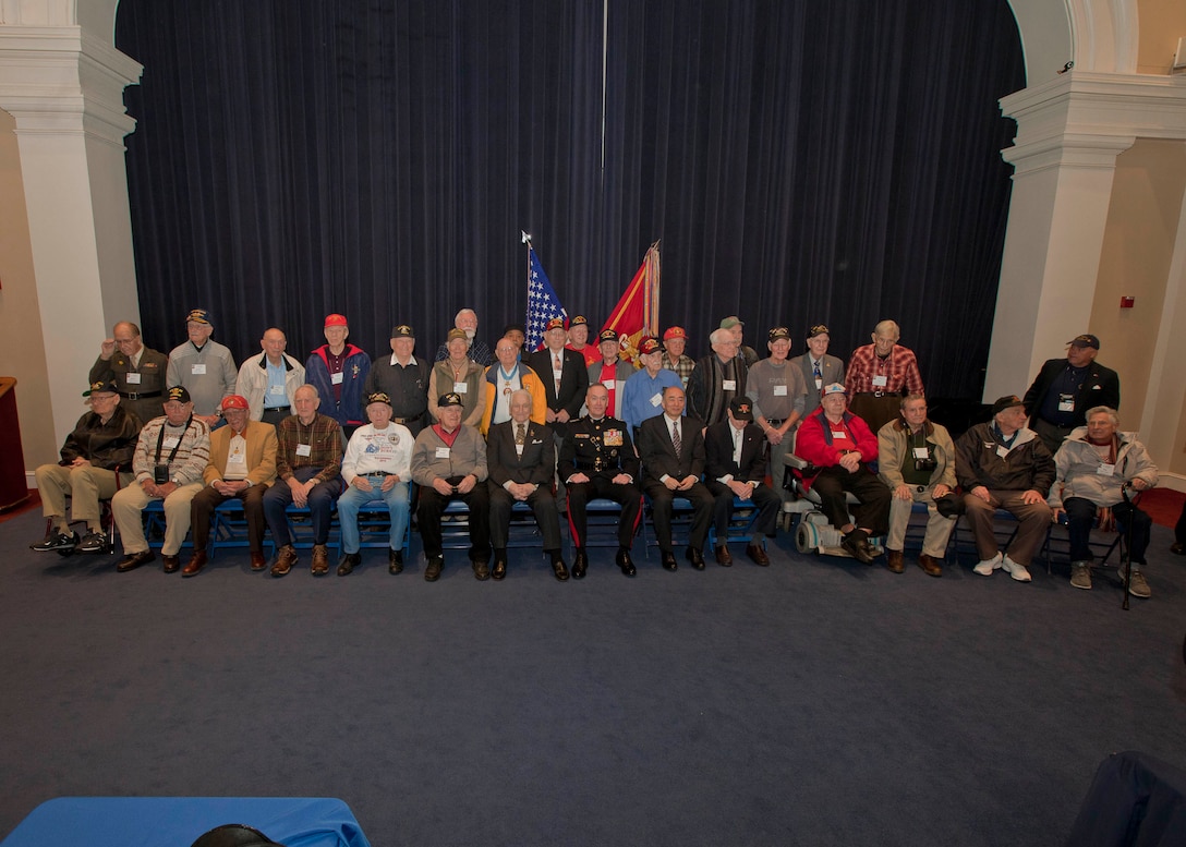 Commandant of the Marine Corps, Gen. Joseph F. Dunford, Jr., poses for a photo with Iwo Jima veterans during an Iwo Jima reunion at Marine Barracks Washington, D.C., Feb. 19, 2015. The event commemorated the 70th Anniversary of the Battle of Iwo Jima with veterans, families, dignitaries and service members. (U.S. Marine Corps photo by Cpl. Lauren L. Whitney/Released)