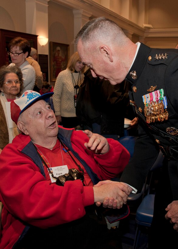 Commandant of the Marine Corps, Gen. Joseph F. Dunford, Jr., right, shakes hands with an Iwo Jima veteran during an Iwo Jima reunion at Marine Barracks Washington, D.C., Feb. 19, 2015. The event commemorated the 70th Anniversary of the Battle of Iwo Jima with veterans, families, dignitaries and service members. (U.S. Marine Corps photo by Cpl. Lauren L. Whitney/Released) 