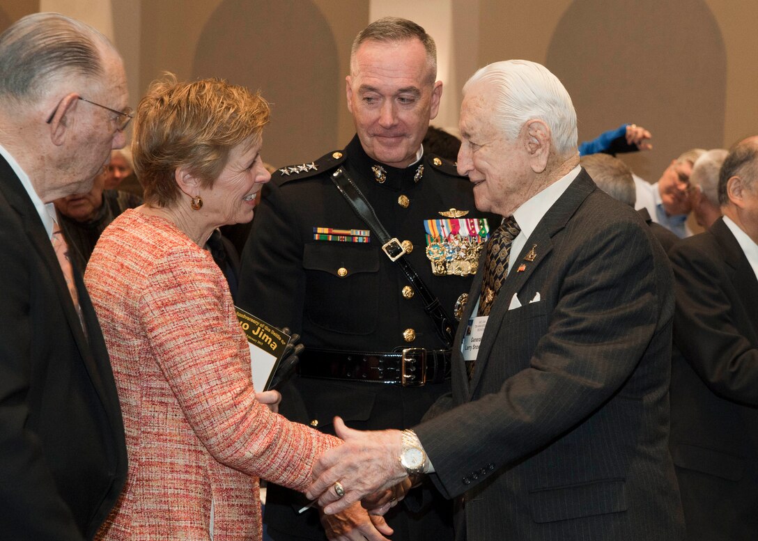 Commandant of the Marine Corps, Gen. Joseph F. Dunford, Jr., center, introduces his wife, Ellyn Dunford, to retired Lt. Gen. Lawrence Snowden, right, during an Iwo Jima reunion at Marine Barracks Washington, D.C., Feb 19, 2015. The event commemorated the 70th Anniversary of the Battle of Iwo Jima with veterans, families, dignitaries and service members. (U.S. Marine Corps photo by Cpl. Lauren L. Whitney/Released)