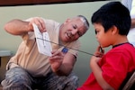 Staff Sgt. Bill McConaha, an optometry technician with the 178th Medical Group of the Ohio Air National Guard performs an eye screening to test near vision on a patient at Pu’ukohola Heiau National Historic Site in Kona, Hawaii June 8, 2010. The 178 MDG is on a two-week medical training deployment, which provides free medical services to underserved Kona communities.