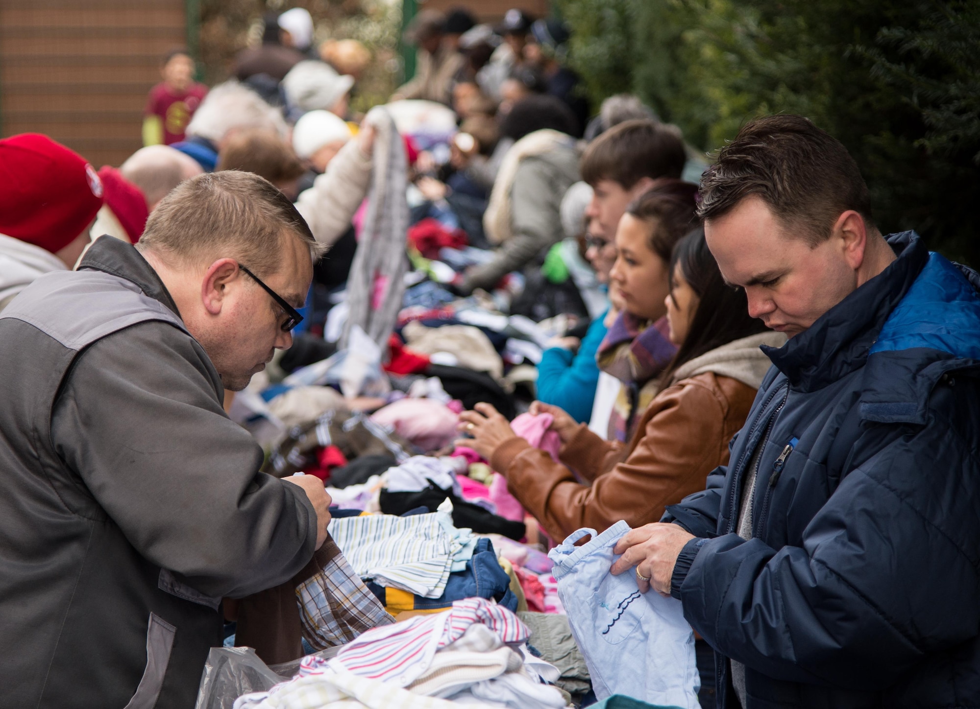 Maj. Matthew Boyd, right, arranges donated clothing Feb. 21, 2015, in Kaiserslautern, Germany. Boyd continues his family’s tradition of serving in the military, working as a chaplain and offering guidance to those in need. Boyd is the 86th Airlift Wing chaplain. (Courtesy photo)