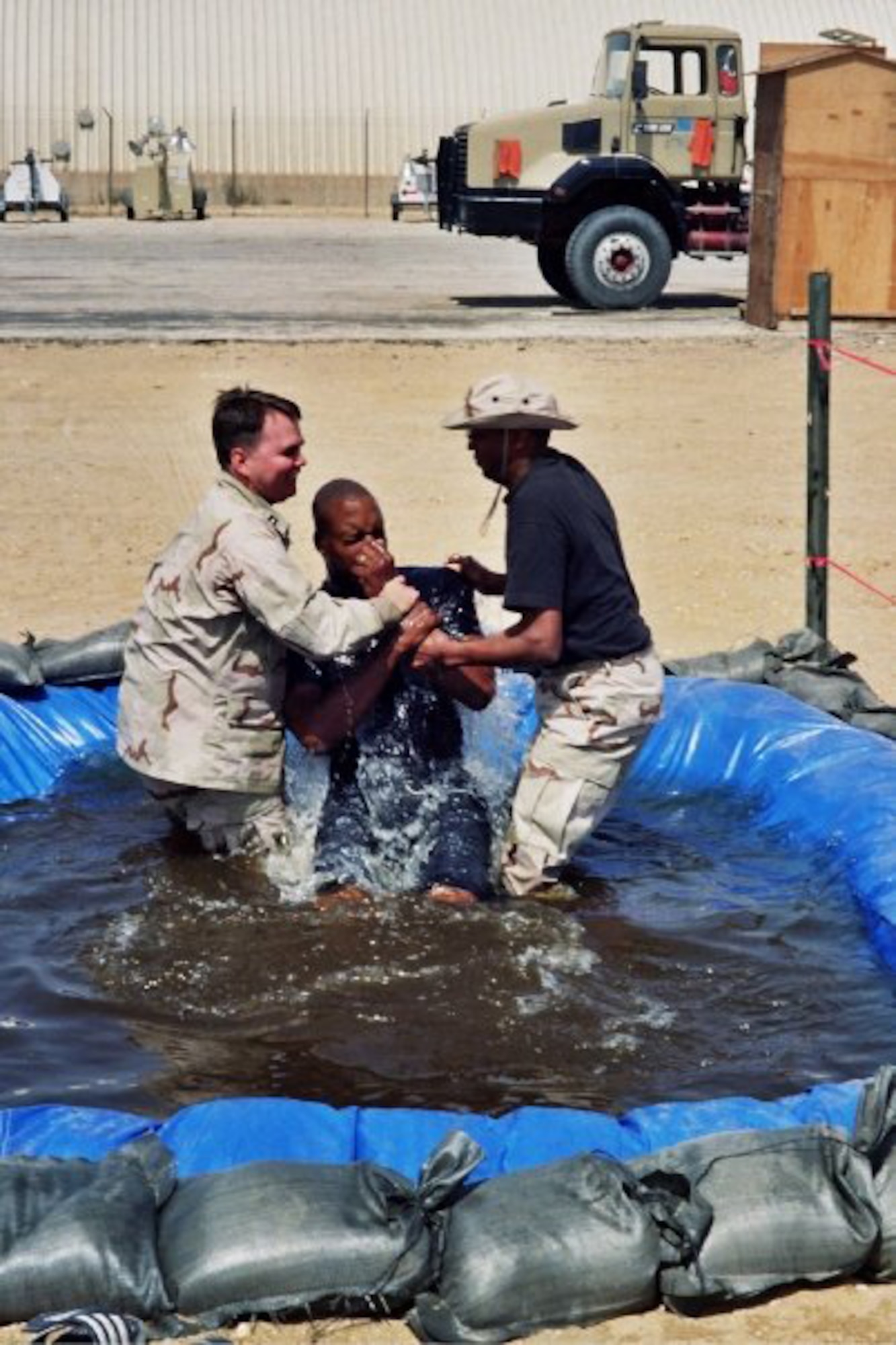 (Then) Capt. Matthew Boyd (left) baptizes a service member during a deployment to the Middle East in 2009. Now a major, Boyd continues his long lineage of serving in the military as a chaplain offering guidance and contentment for those in need. (Courtesy photo)