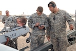 From left, Pfc. Travis Hampton, Staff Sgt. Donald Segura and Sgt. Mike Lejeune, complete pre-combat checks and inspections on the RQ-7B Shadow Tactical Unmanned Aircraft System before its first flight from Contingency Operating Base Adder, Iraq May 21, 2010. The Soldiers are deployed with the Unmanned Aircraft Systems Platoon, Brigade Special Troops Battalion, 256th Infantry Brigade Combat Team, 13th Sustainment Command (Expeditionary) in support of Operation Iraqi Freedom.
