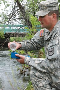 Sgt. Joseph Meyer, a water purification specialist assigned to the South Dakota Army National Guard’s Company A, 139th Brigade Support Battalion, tests the water at Rapid Creek during the 26th annual Golden Coyote training exercise, June 13, 2010.  The 139th BSB, based out of Watertown, S.D., provides potable water to nearly 2,200 personnel attending the event throughout the Black Hills of South Dakota.