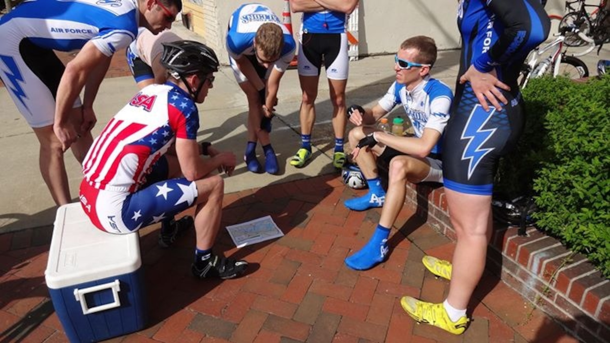 Maj. Ian Holt, seated left, shares strategy and wisdom with members of the U.S. Air Force Academy Falcons cycling team as they prepare for a 2014 team time trial in Richmond, Va. Holt is the Headquarters Air Force Space Command vault concepts lead. (Courtesy photo)
