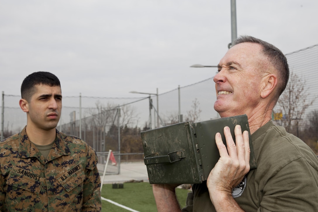 U.S. Marine Corps Sgt. Nicholas F. Sanquist, left, an administrative assistant with the office of the commandant, supervises Commandant of the Marine Corps, Gen. Joseph F. Dunford, Jr., during a Combat Fitness Test (CFT) at Washington, D.C., Dec. 15, 2014. The CFT is a semi-annual requirement for all Marines to assess a Marine’s physical capacity in a broad spectrum of combat related tasks. (U.S. Marine Corps photo by Sgt. Gabriela Garcia/Released)