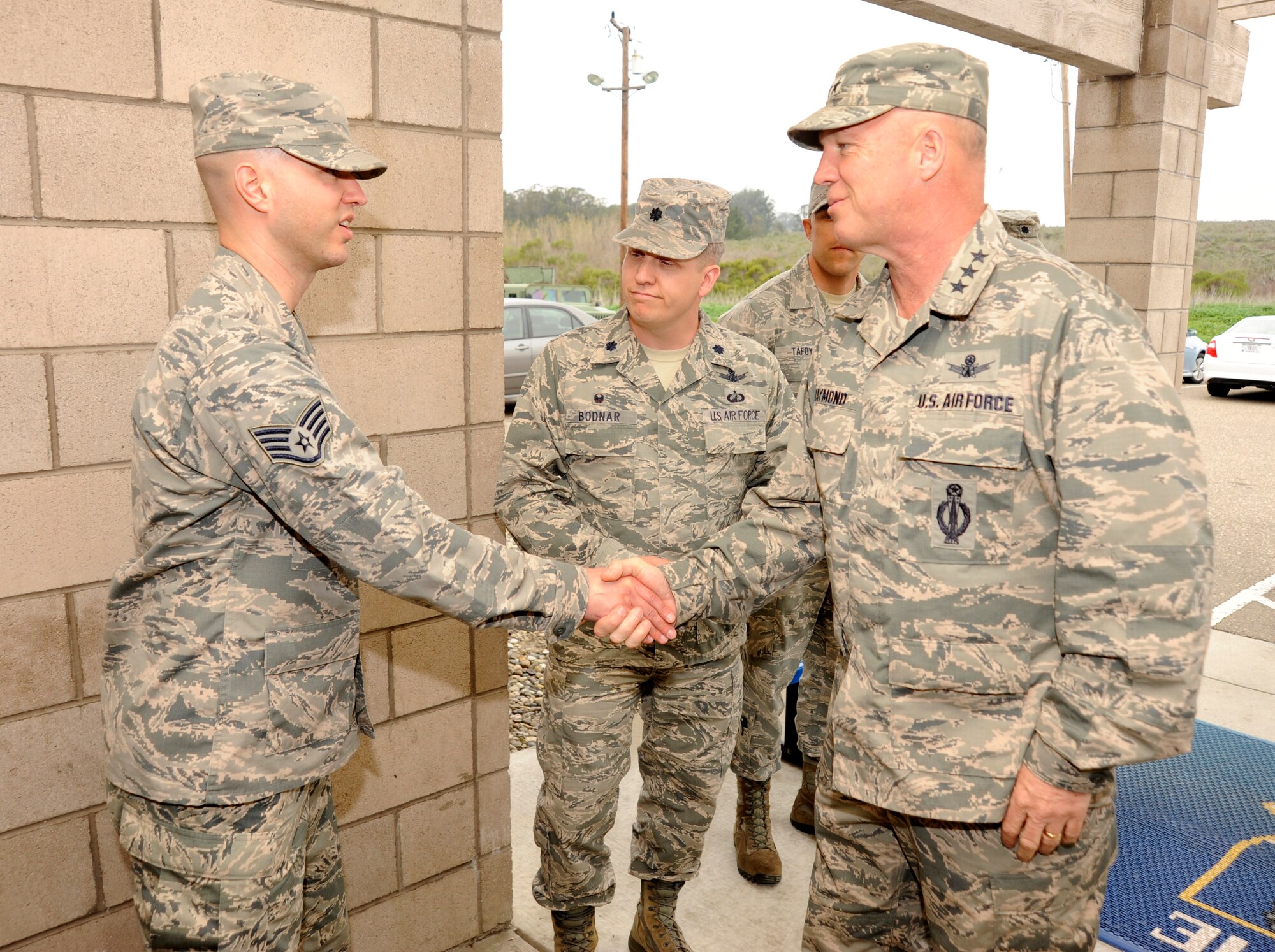 Staff Sgt. Robert Coleman, 4th Space Launch Squadron facility manager, greets Lt. Gen. John Raymond, Commander, 14th Air Force (Air Forces Strategic) and Joint Functional Component Command for Space, during a base tour, Feb. 17, 2015, Vandenberg Air Force Base, Calif. The tour highlighted several base support organizations such as the 30th Security Forces Squadron and 30th Civil Engineer Squadron.   (U.S. Air Force Photo by Airman Robert J. Volio/Released)